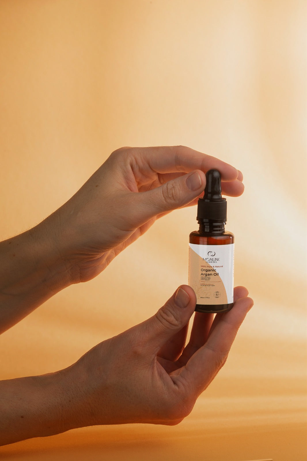 Women Holding argan oil tube